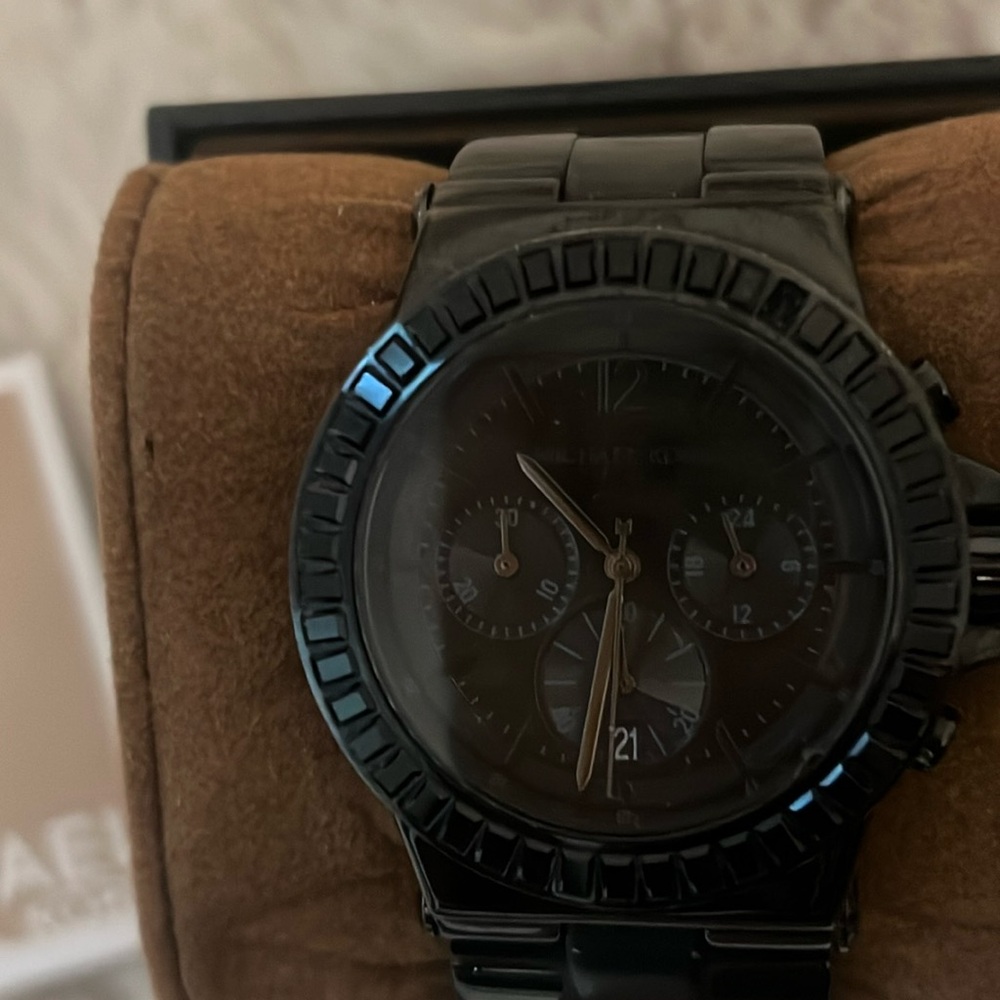 All black Michael Kors watch with stones (missing one that can be replaced!
